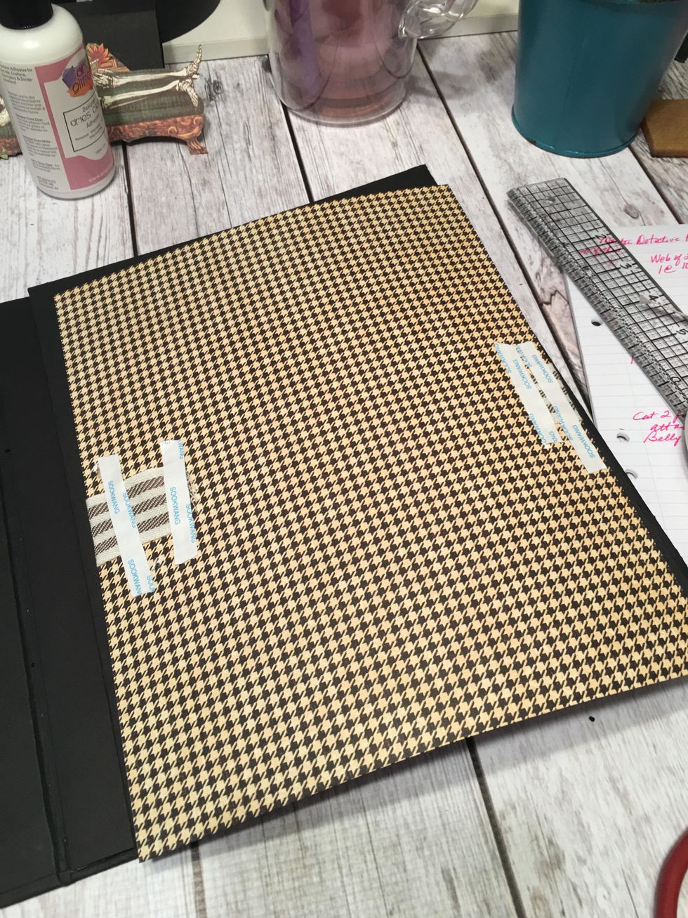 Turn the patterned papers over and use tape to attach one length of ribbon to the back side of each patterned piece as shown. Pull the ribbon slightly tight so the paper bows a bit.