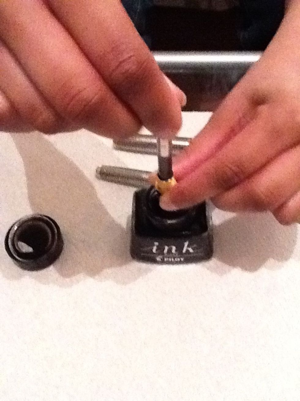 Turn the plunger screw to cause the plunger to move up and down. Do this a handful of times to fill the cartridge with ink.