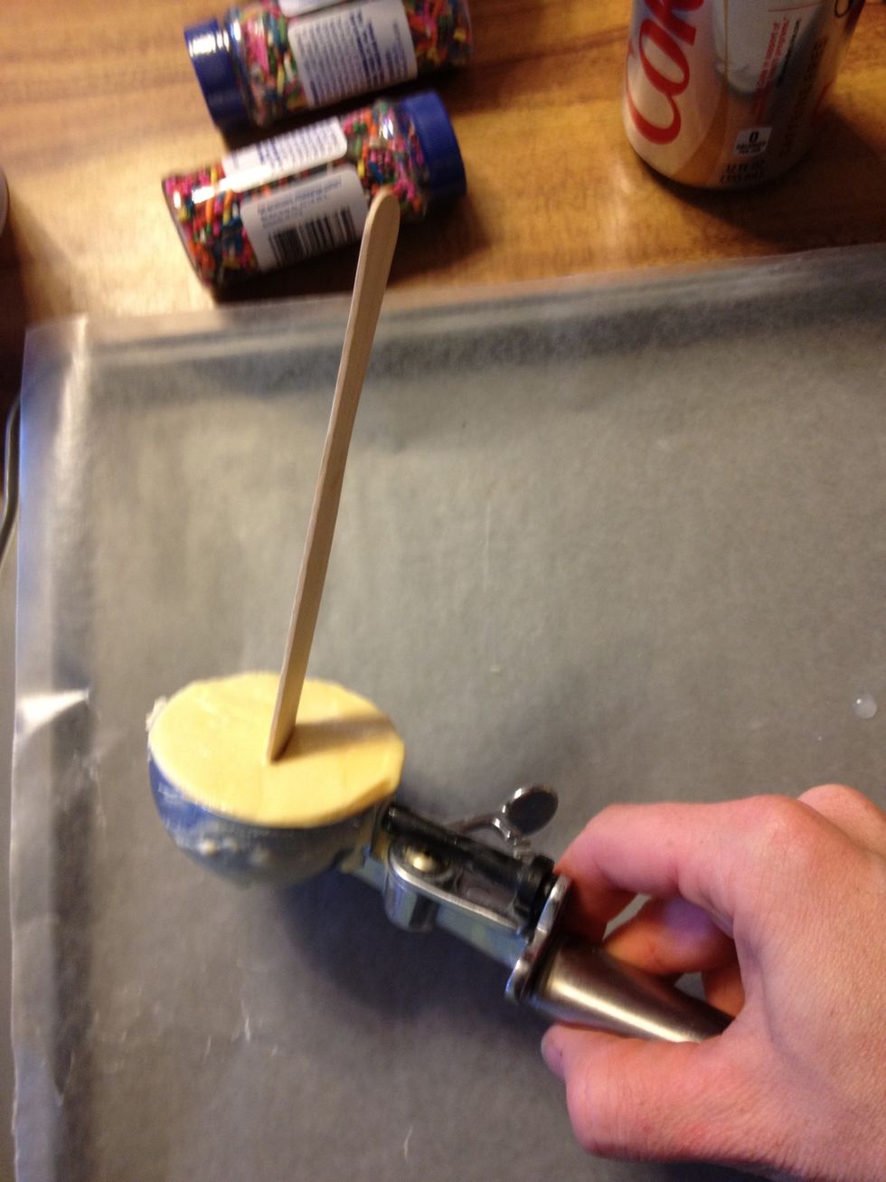 Turn the scoop over (stick side down- not shown). Squeeze lever to remove ice cream.