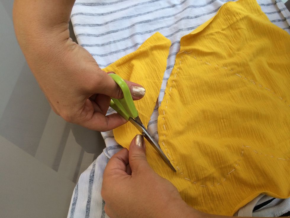 Turn the shirt inside out and cut out the extra yellow fabric.
