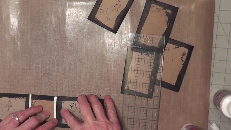 Turn the spine piece attached to the Tyvek over and apply glue to the Tyvek flaps and attach the two cover (glued shut) tubes on to the Tyvek flaps. Leave a 1/4" space between each cover & the spine.