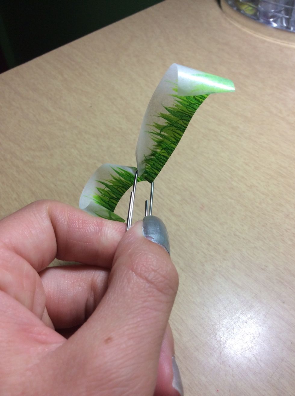 Turn the tape toward the top of the paperclip