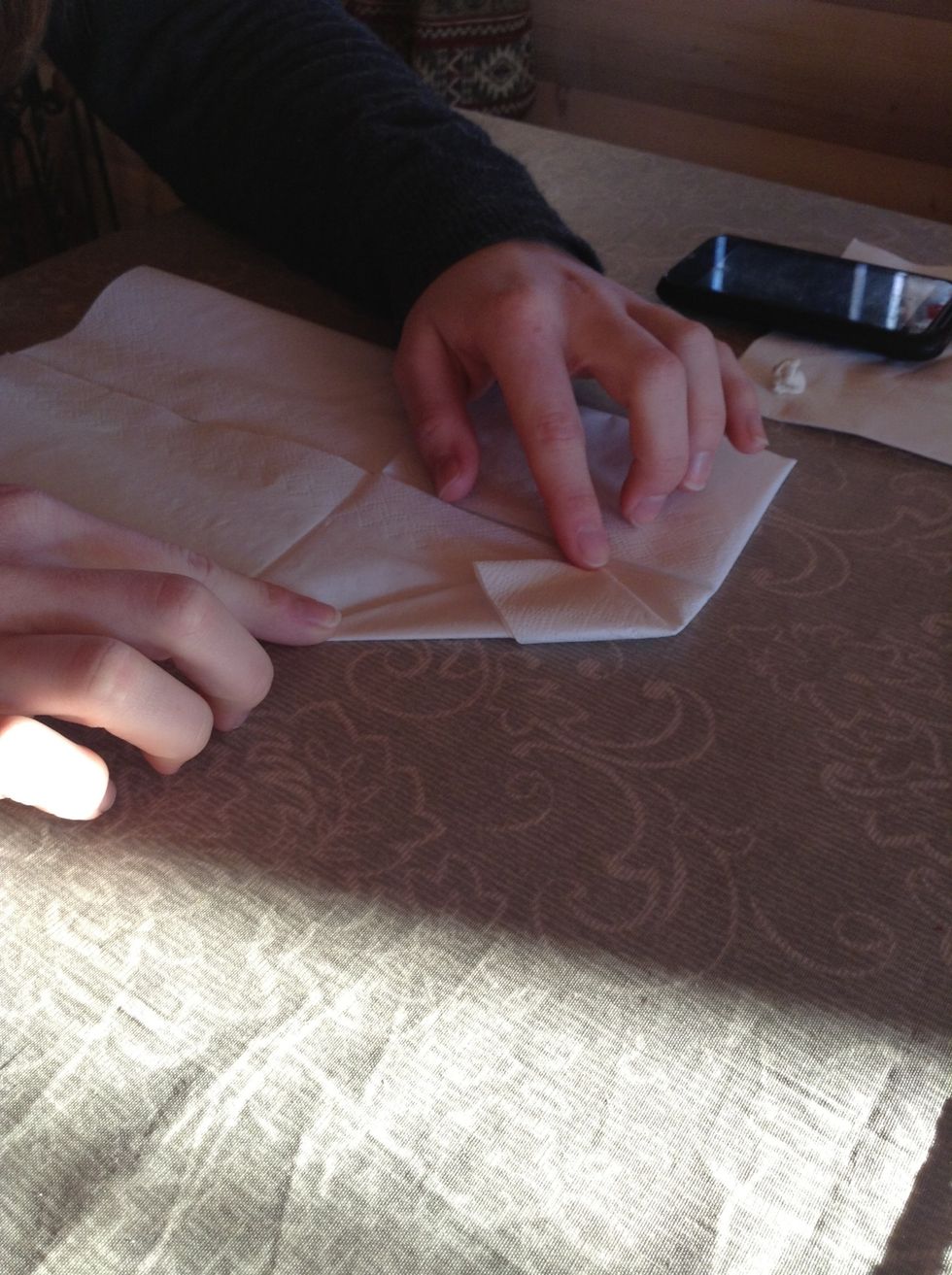 Turn the upper corner down against the middle.