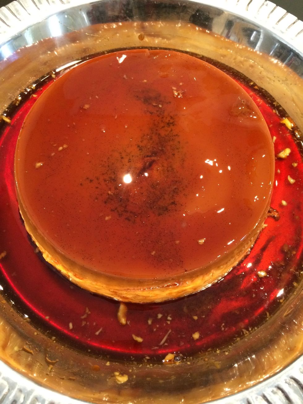 Turn upside down. A metallic serving dish gives a beautiful reflection of the desert and the transparency of the golden caramel...otherwise any serving dish that holds the liquid caramel.