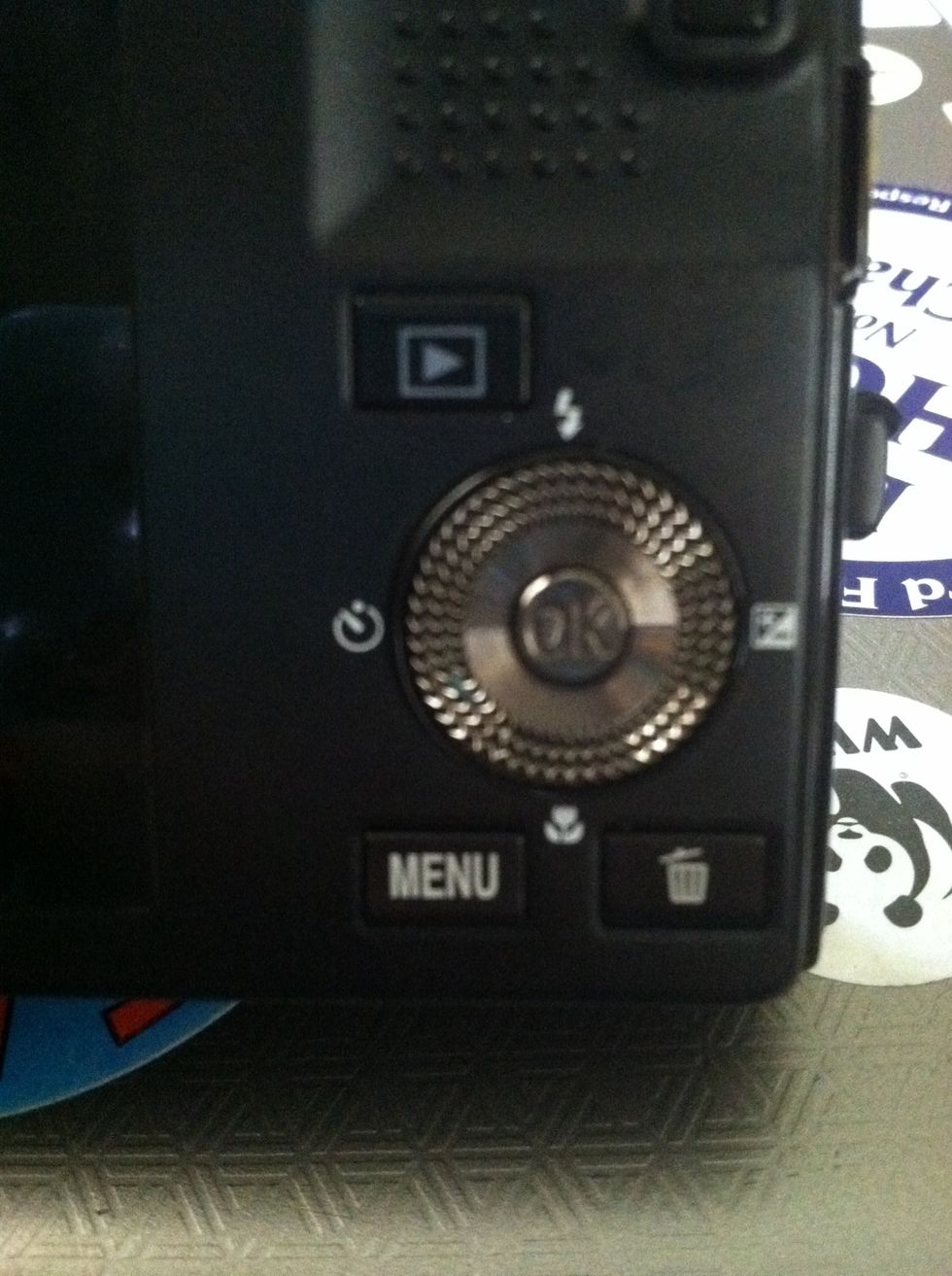 Turn your camera on, put it on "AUTO" mode, and turn on the macro setting! This is typically a button symbolise by a flower. Mine is the button between the menu and delete buttons. See the flower?