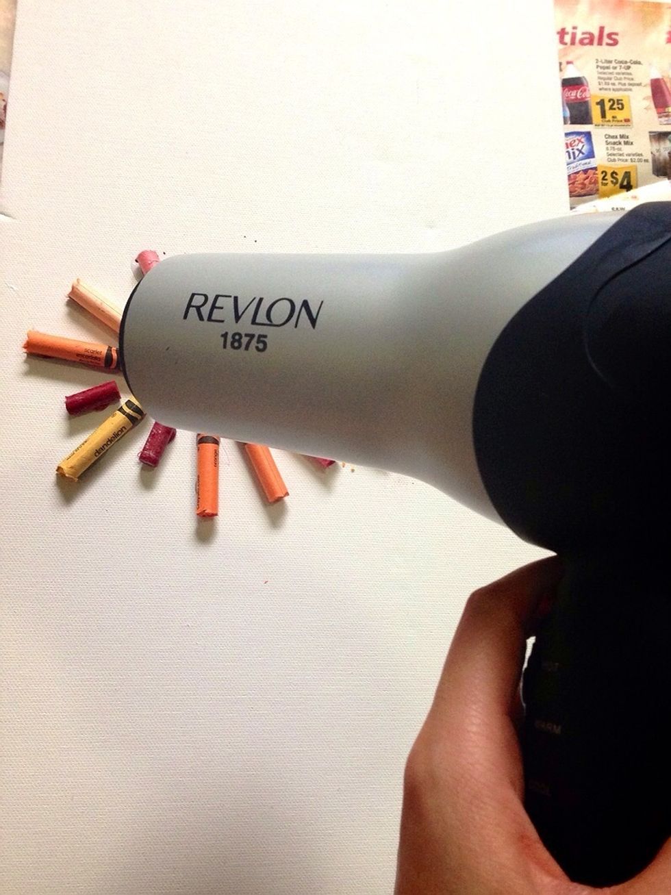 Turn your hair dryer on high heat and blast away! Once the wax of the crayon melts, you need to pick the canvas up and start shaping the design you want by moving the canvas around.