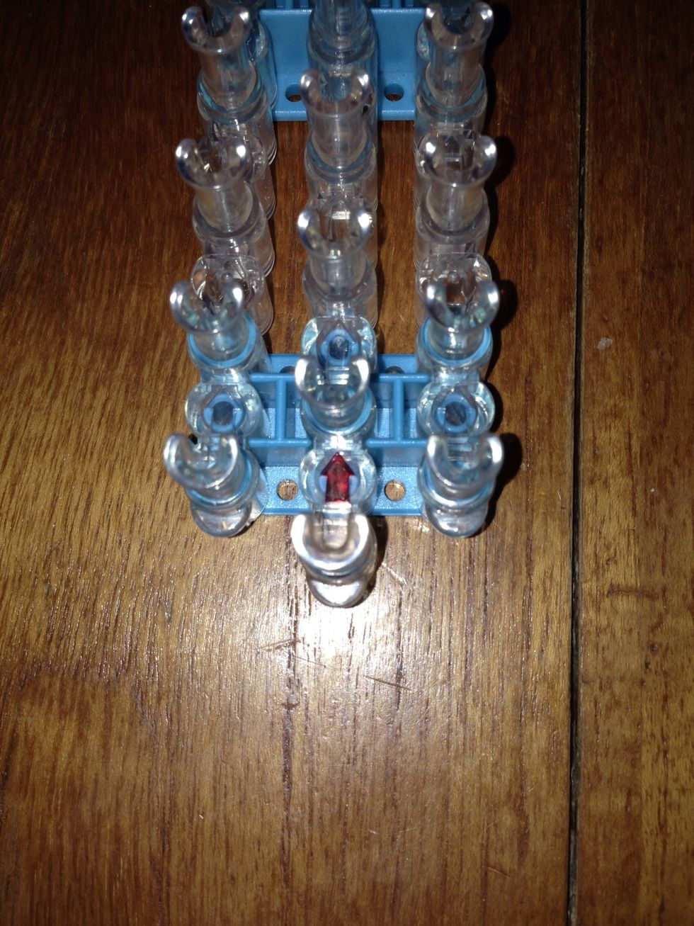 Turn your loom around so that the red arrow is facing away from you.