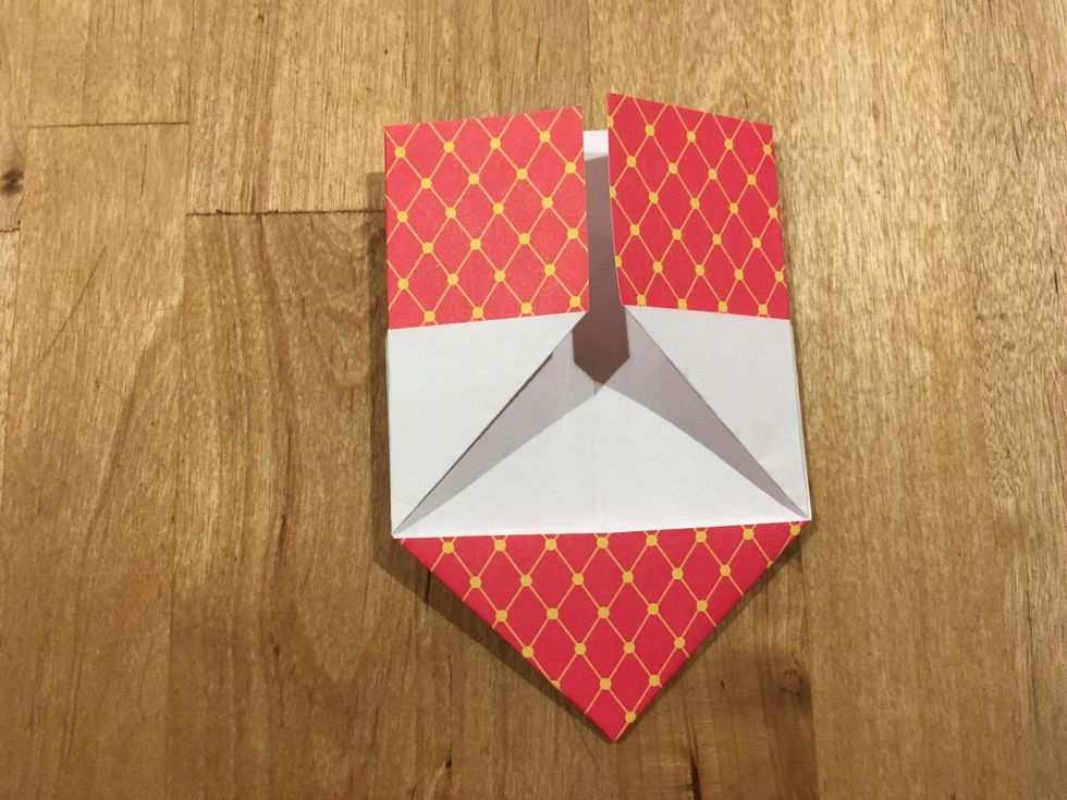 Turn your paper over. Fold the top edges to the verticle lines.