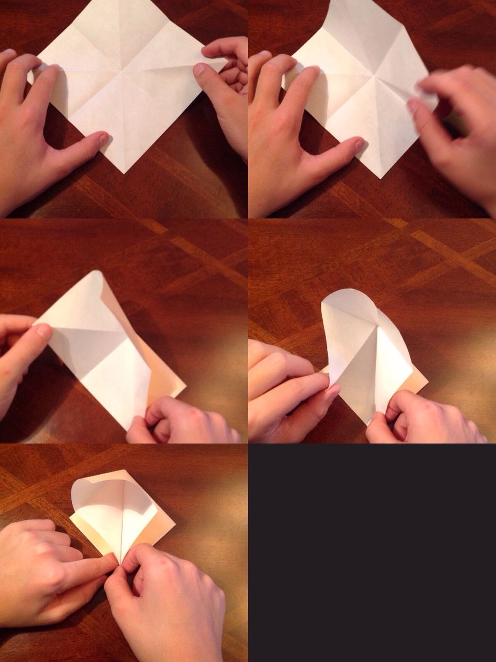 Turn your paper to make a diamond shape. Take the right corner, bring it down to the bottom, and hold it there. Do the same with the left corner and hold with the same hand.