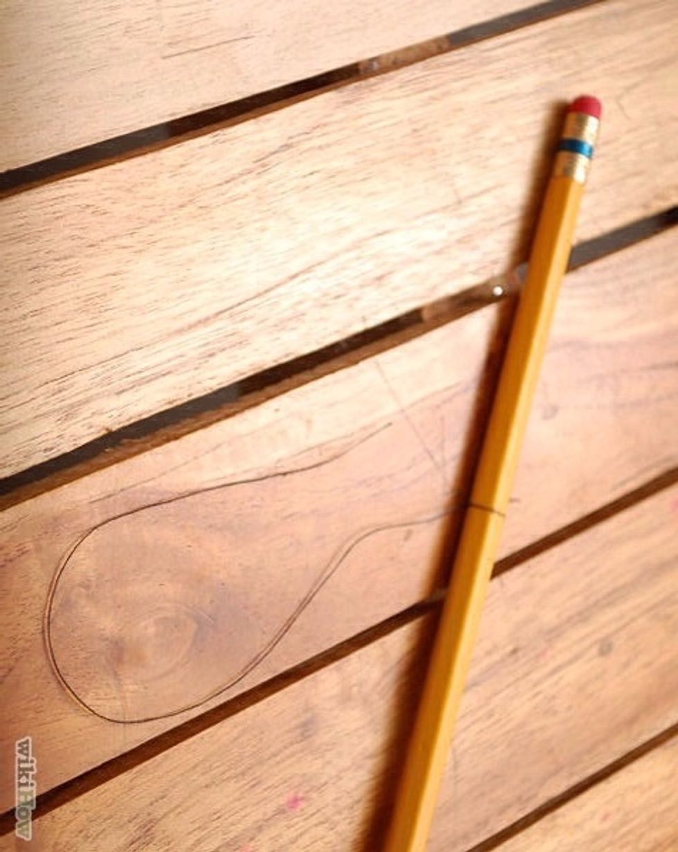 Twist a piece of cotton string around the middle of the stick. It should be long enough so that when the stick is placed over the top of the glass the string will hang just short of the bottom