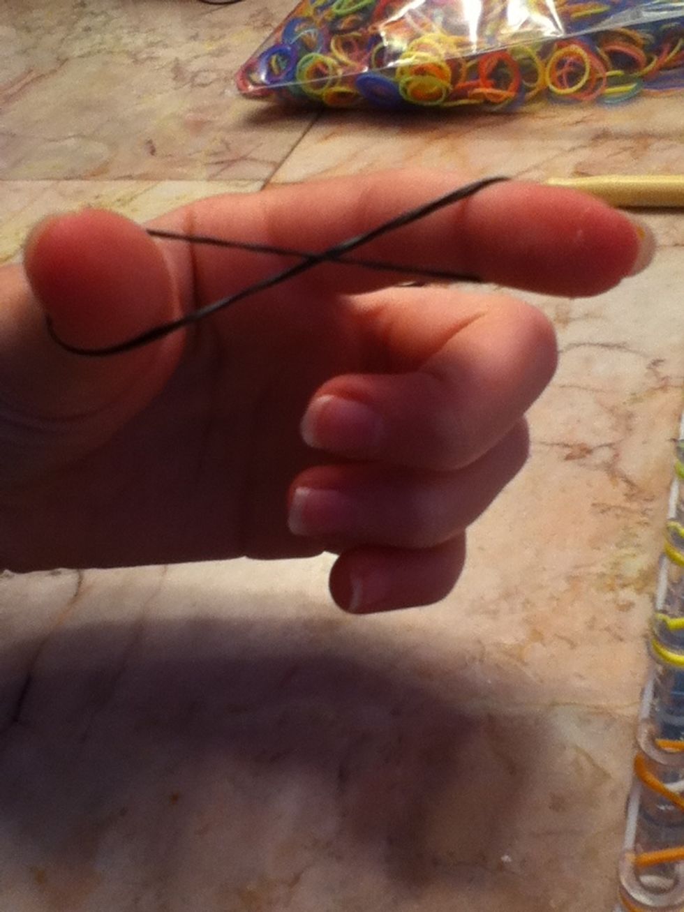 Twist a rubber band (black) into a figure eight