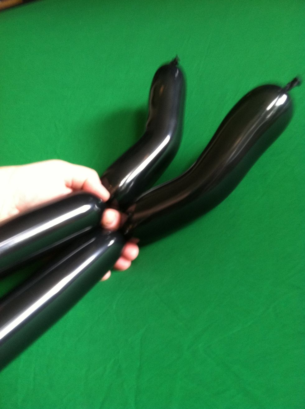 Twist off a 9" section on each balloon and give it a little bend.