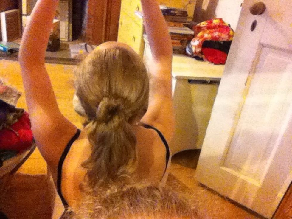 Twist one part of your hair and wrap it around your pony tail putting two bobby pins in to hold it up