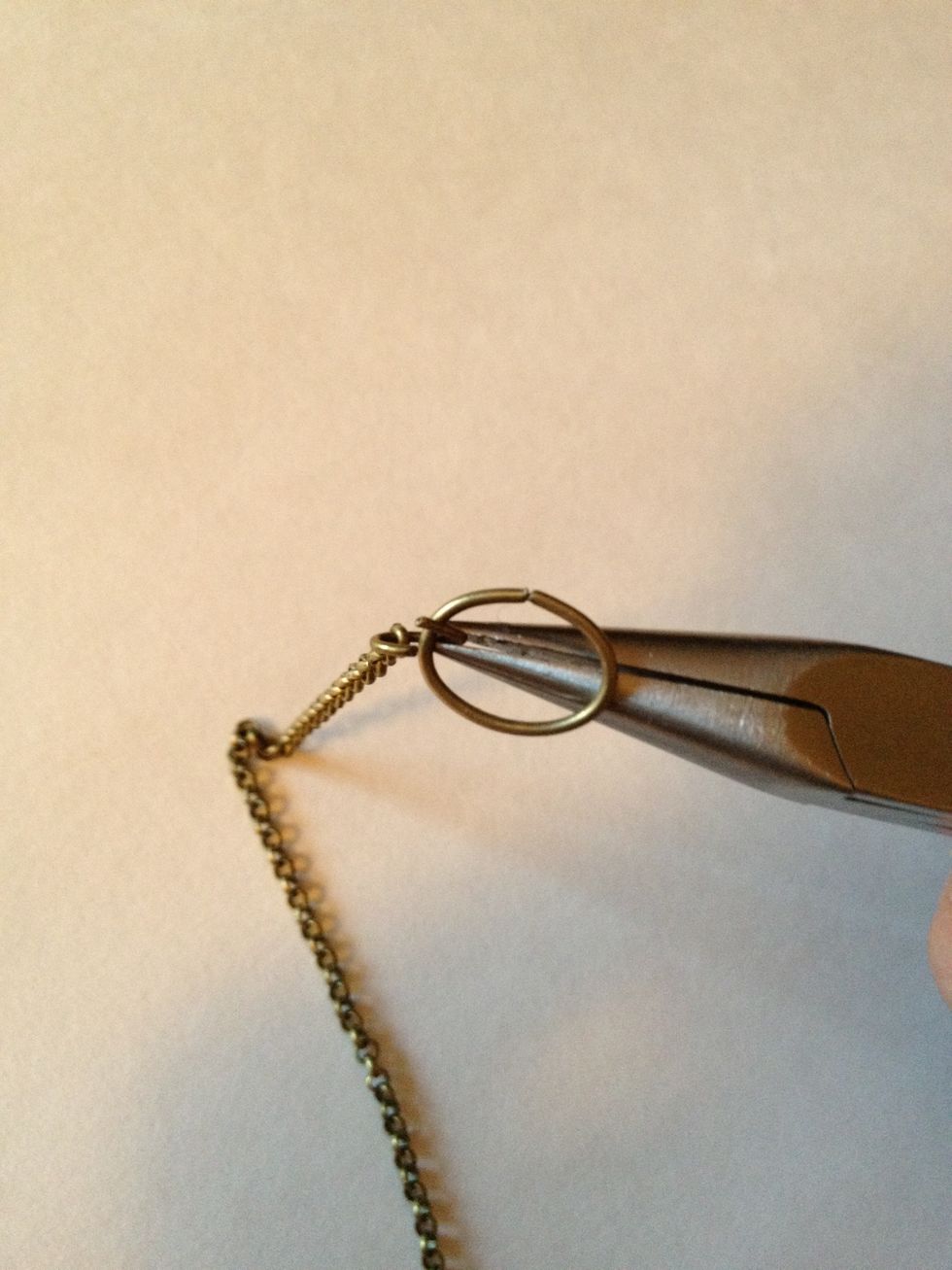 Twist other small jump ring open and attach other length of chain as well as large jump ring.
