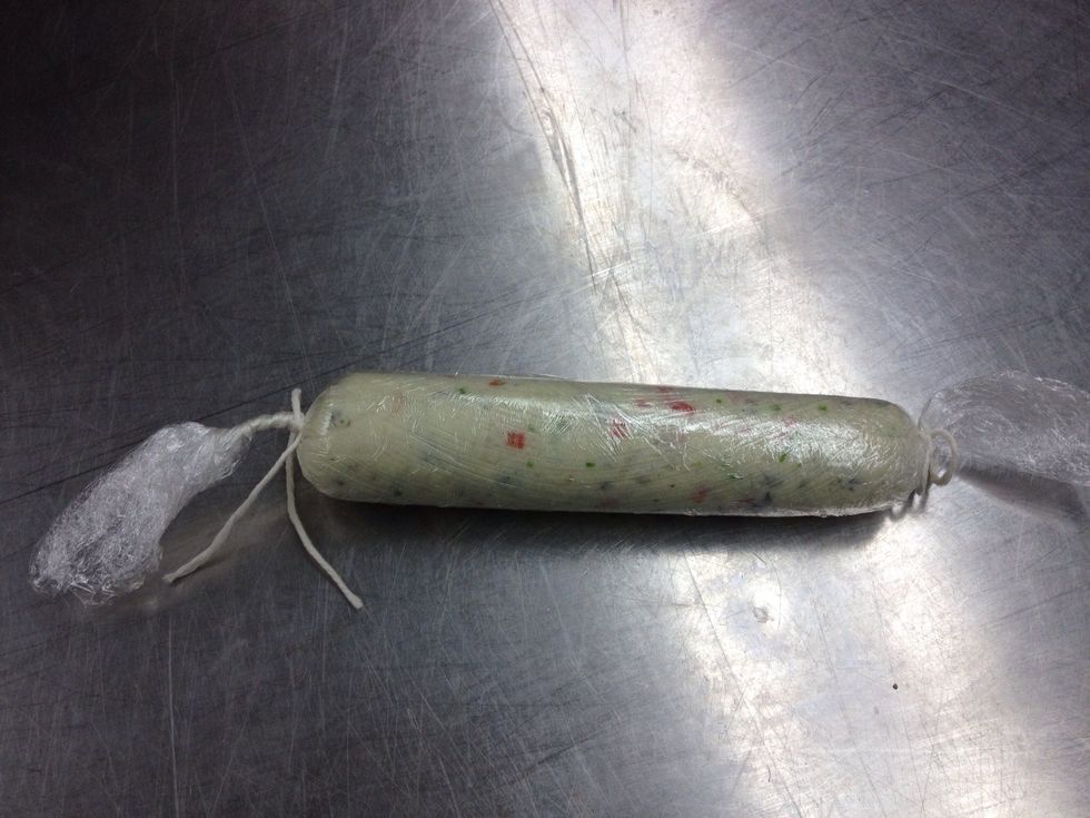 Twist plastic to form sausage. Tie off the other end.