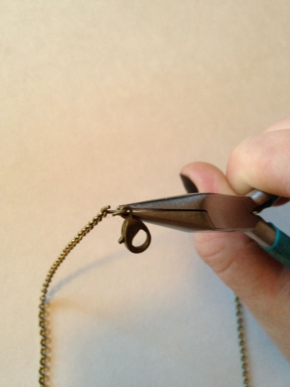 Twist small jump ring open and attach other end of chain as well as clasp.