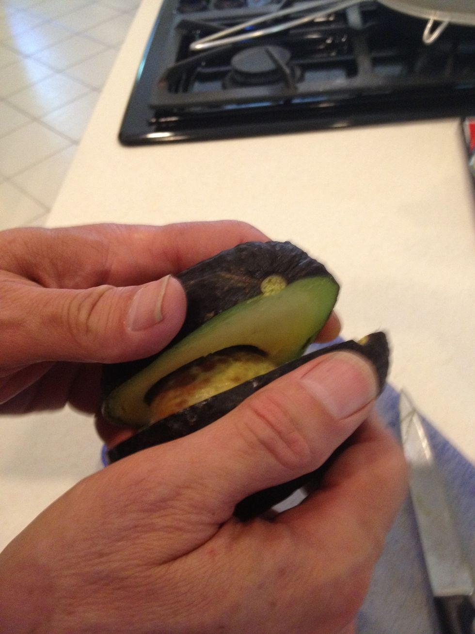 Twist the avocado to separate the halves.