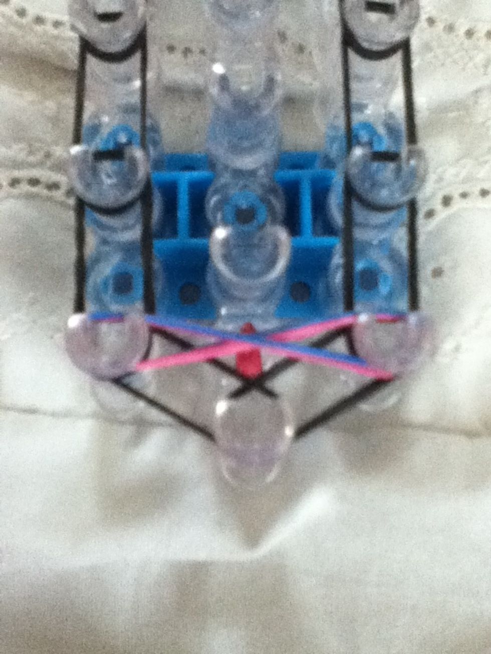 Twist the bands into a figure 8 and place it onto the loom like this