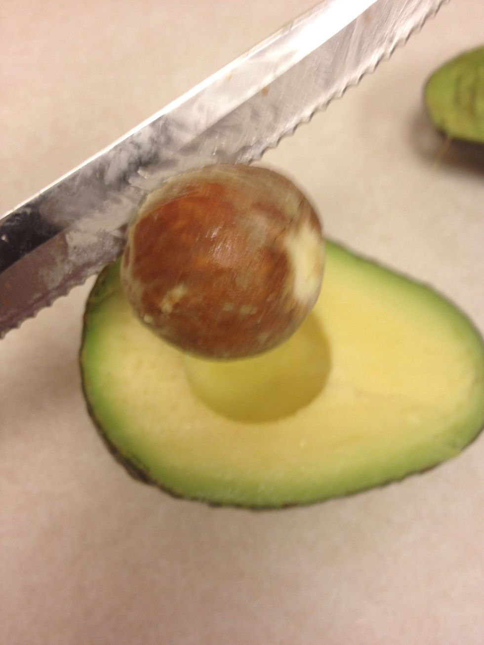 Twist the knife like you would if you were turning on or off the water and the seed will come right out.