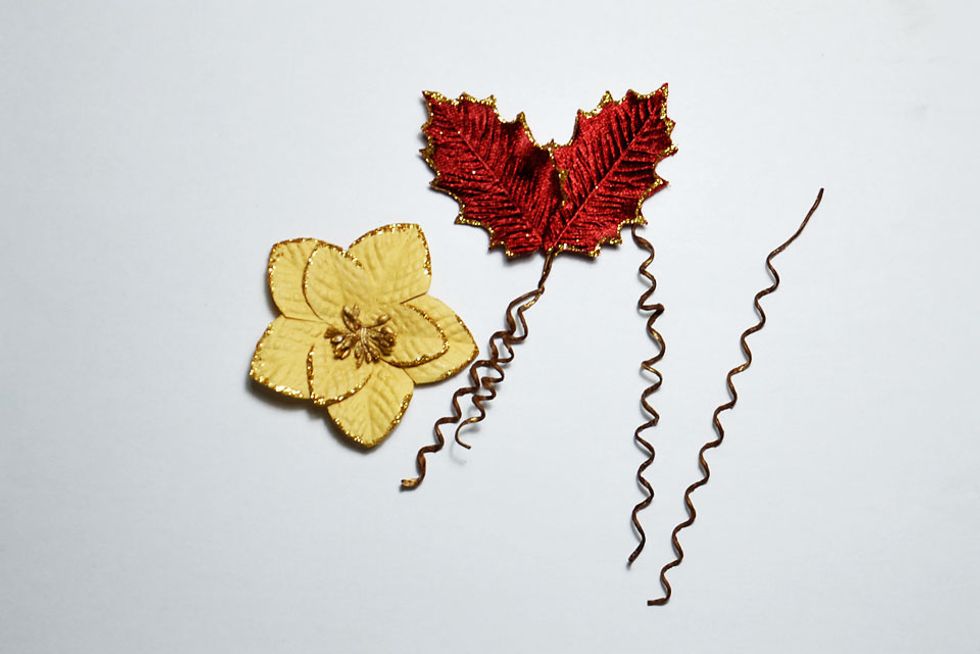 Twist the leave stems together to join them and, with the excess length, wrap it around something round (like a paintbrush) to create twisted stems as shown.