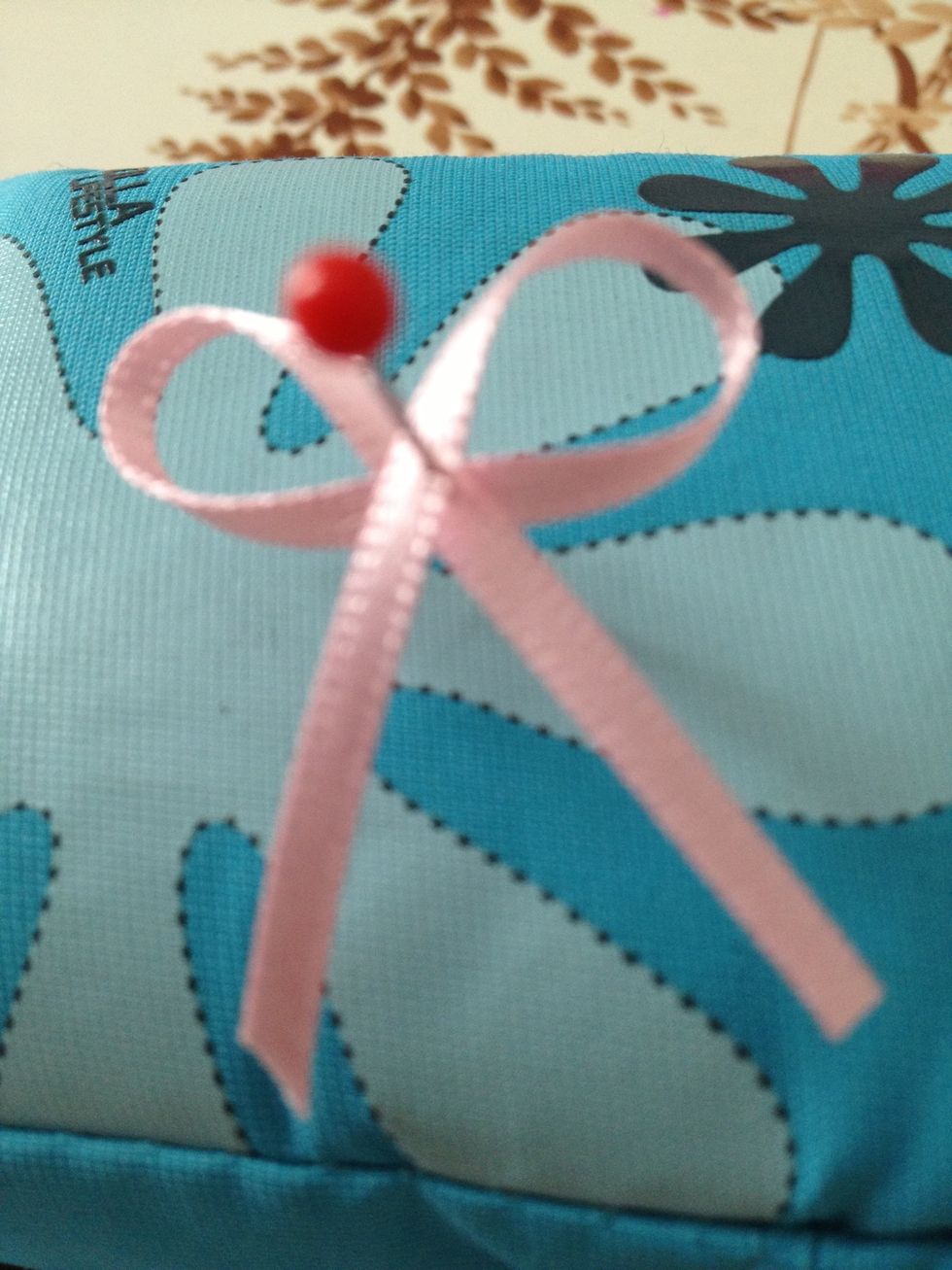 Twist the loop and pin through to make a bow