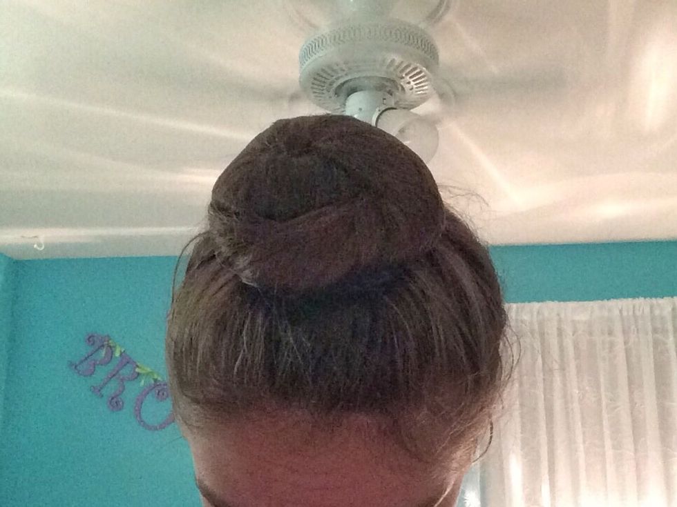 Twist the rest of the hair net and pull it around the bun and then bobby pin it.