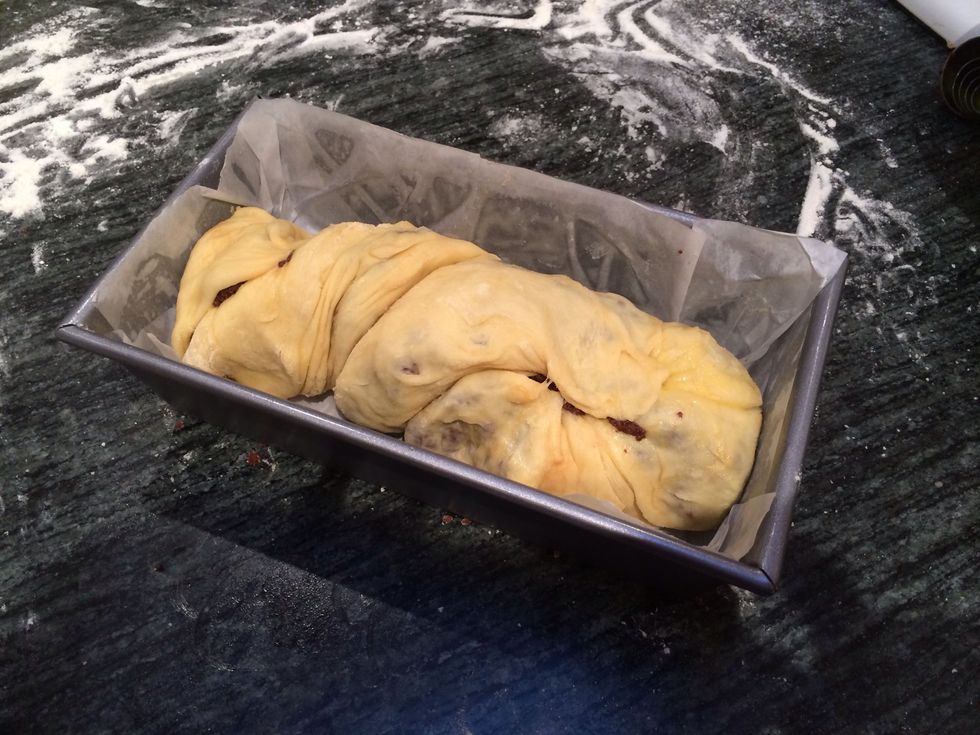Twist the roll 2 turns and transfer it into one of your loaf pans prepared with butter and parchment.
