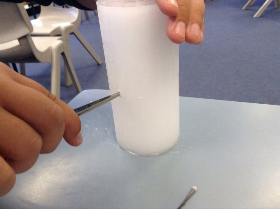 twist the scissors into the candle on each side