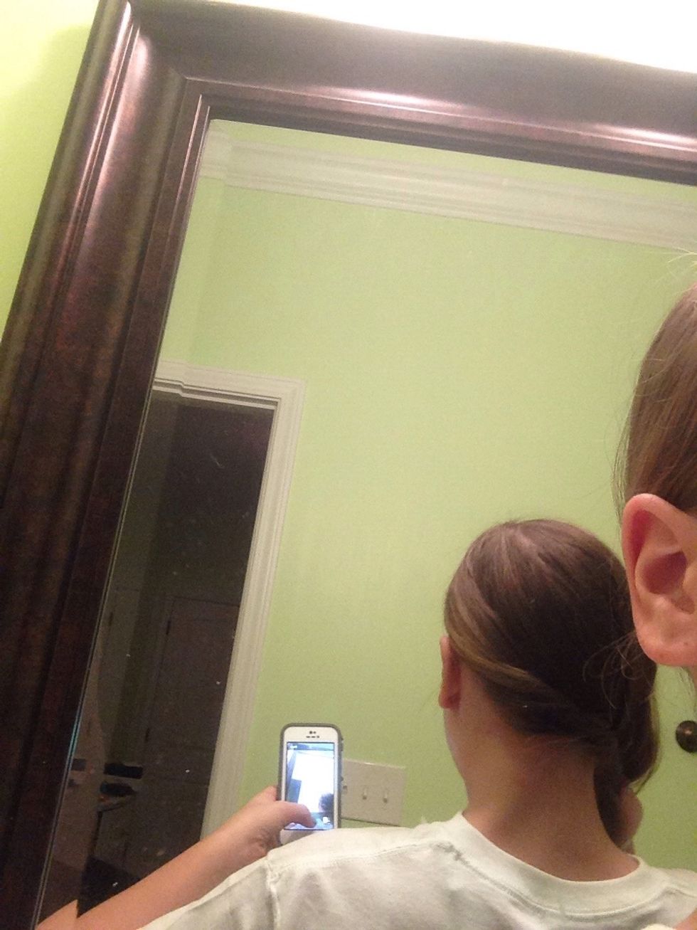 Twist the side behind your ear and add more hair as you get to the other side. Basically like a French twist