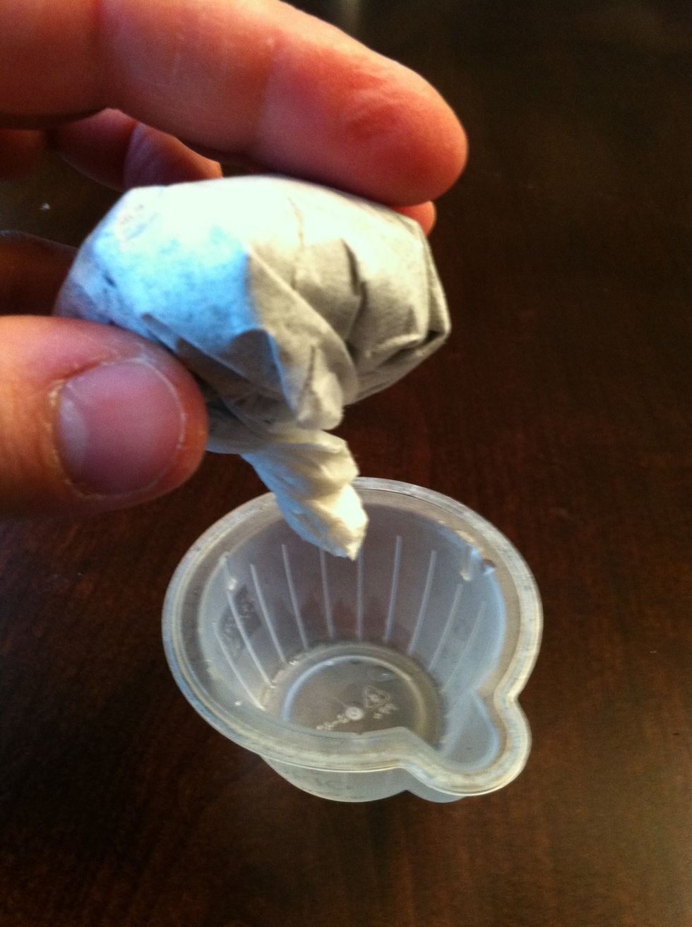 Twist the top of the coffee filter to keep the grounds tightly packed. Then place it in the empty Vue cup with the twisted end down. You may need to staple the bottom shut.