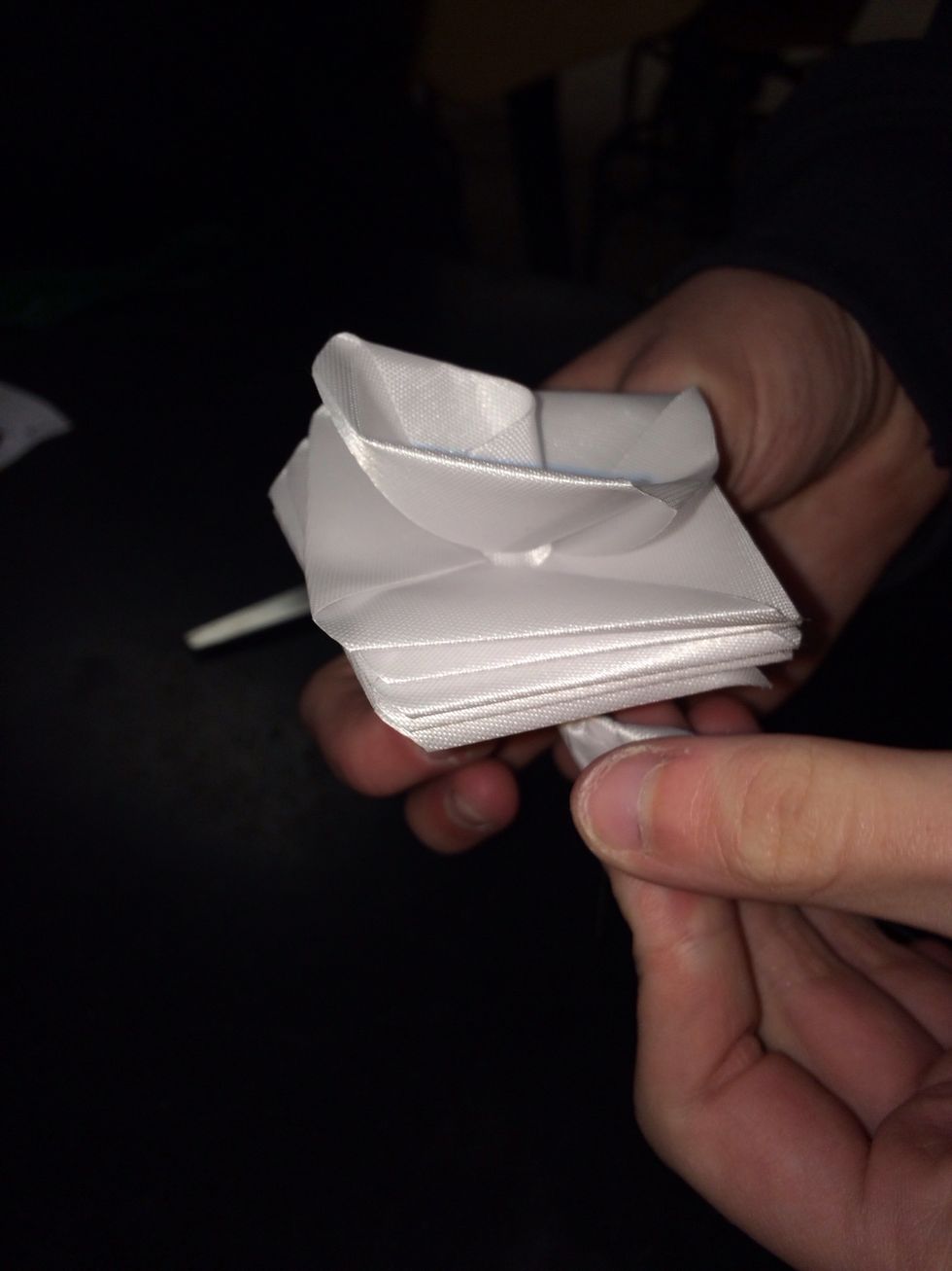 Twist the wire around and begin twisting the ribbon to look like a rose