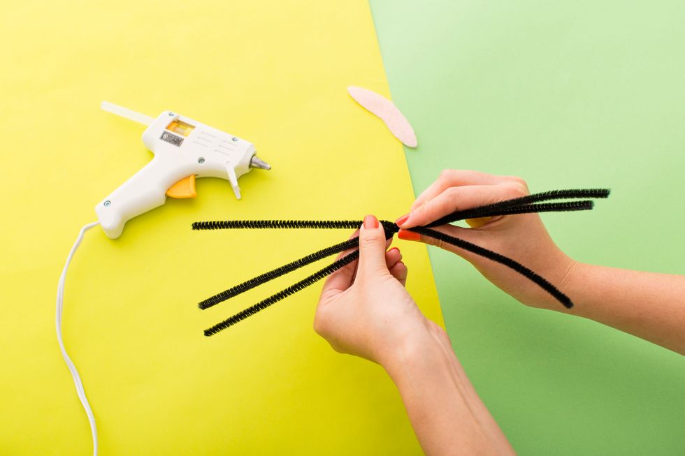 Twist three black pipe cleaners (aka whiskers!) together in the center.