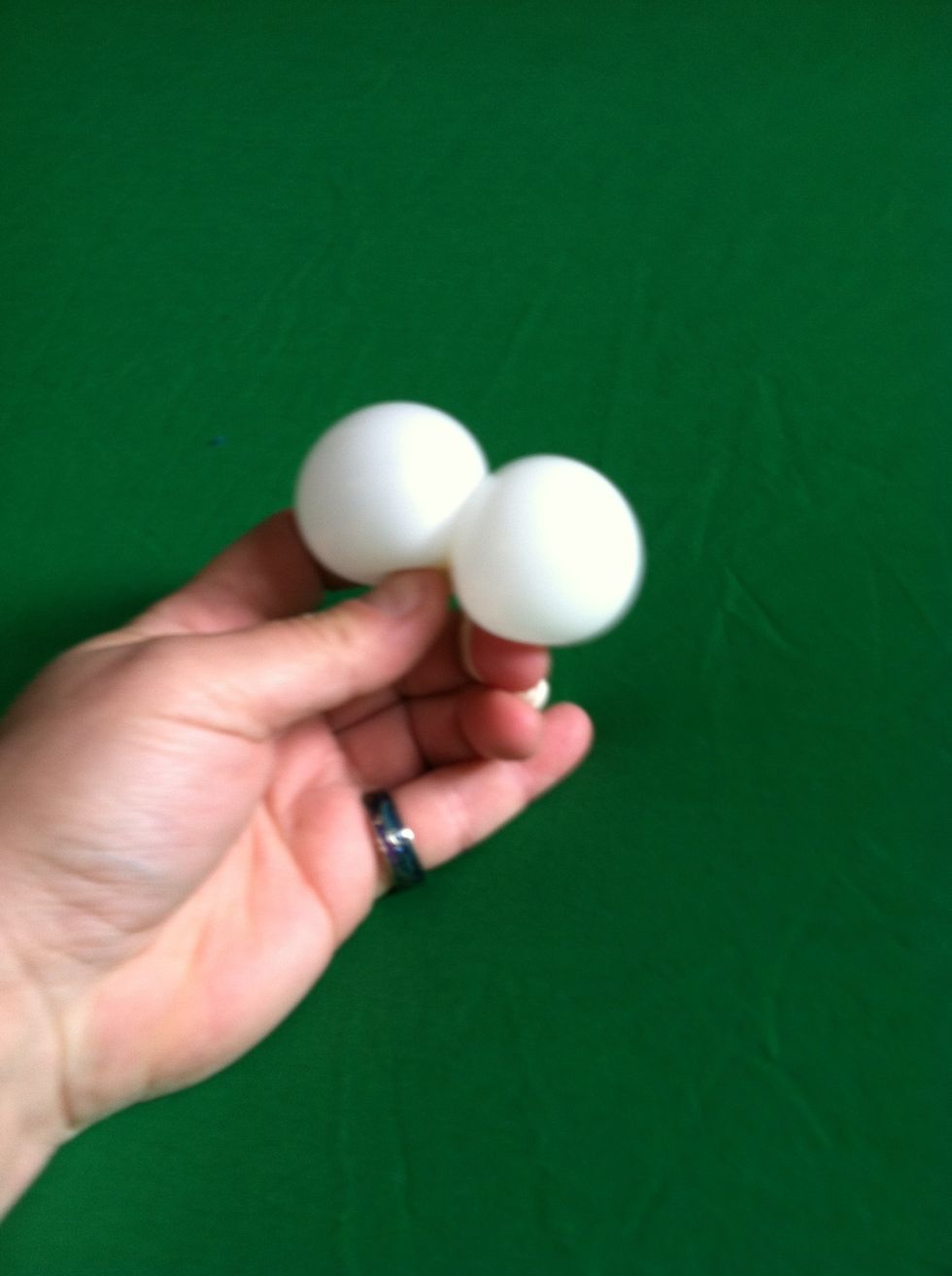 Twist white balloon in half using nozzle to secure