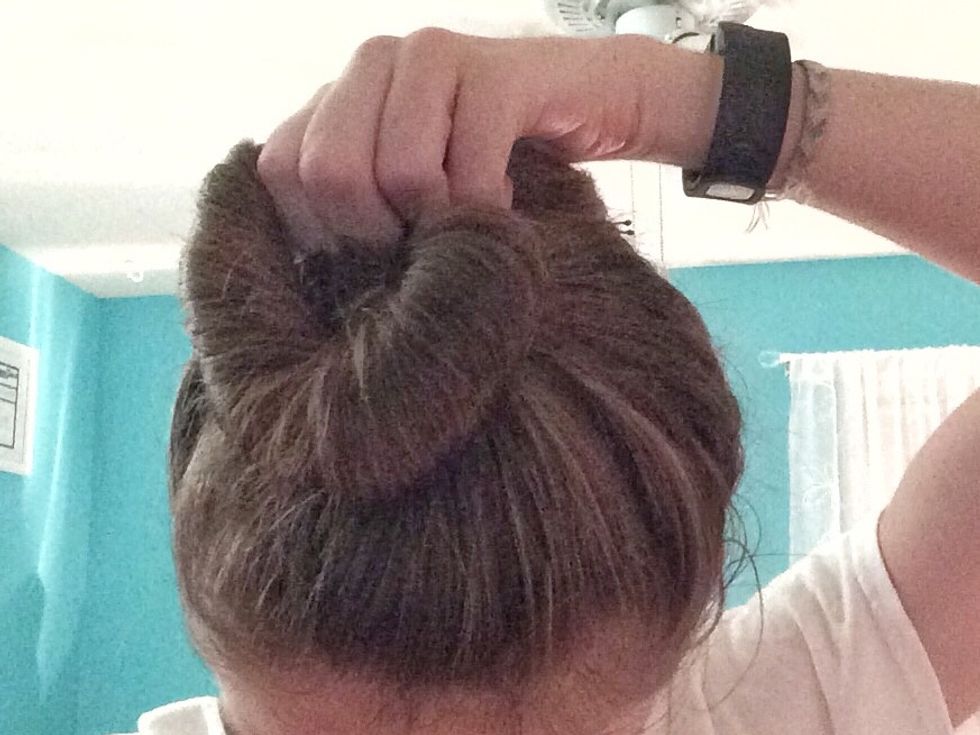 Twist your hair and pull it/wrap it just a little around the pony tail (not completely all the way around) and bobby pin this section down.