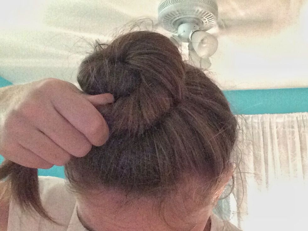 Twist your hair even tighter and pull it just a little more around the pony tail (not completely all the way around) and bobby pin this next section down.