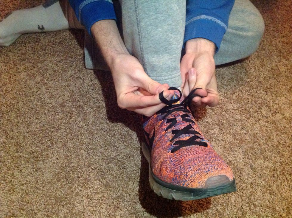 Twist your hands in opposite directions of each other so the laces loop around your fingers differently. One lace will be around your thumb, and the other around your first two fingers.