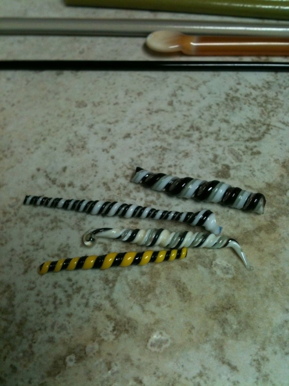 Twisties using stringers of black, white, grey, ivory, & yellow. These are purposely not uniformly sized as this adds to the design & interest of the finished bead.