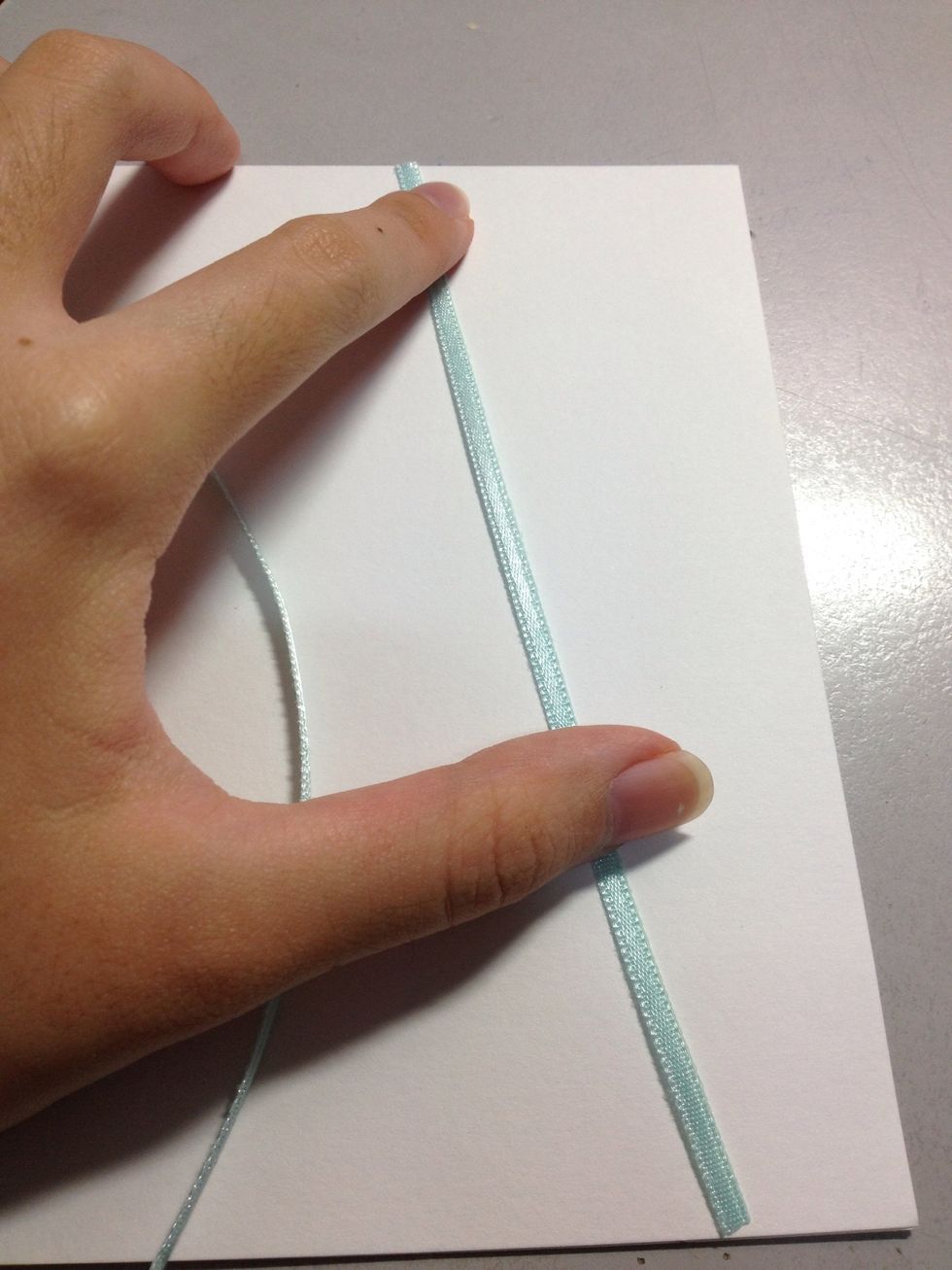 Two ribbons covering semi mid-length (when measured from the centre of the card)...