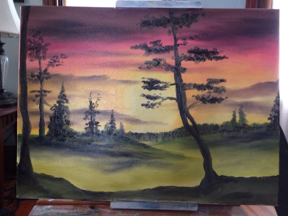 Two trees emerge out of the foreground and go all the way up and off the canvas. Your pinky and fingernails make some twisting branches. Then the mix on your finger dabs on some leaves.