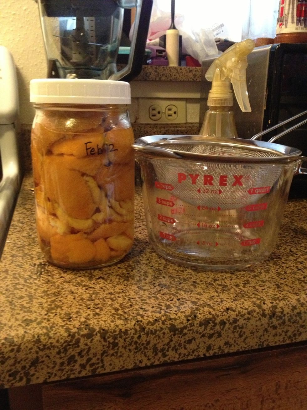 Two weeks later & it's ready to use! As you can see, I'm going to use a strainer to catch any bits as I pour the orange vinegar from the jar.