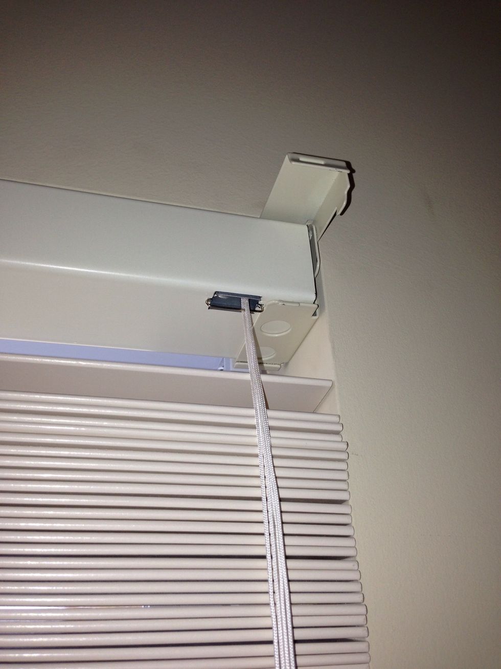 Two well placed screws are all you need for each bracket. Once the brackets are up, slide in the headrail of the blind.