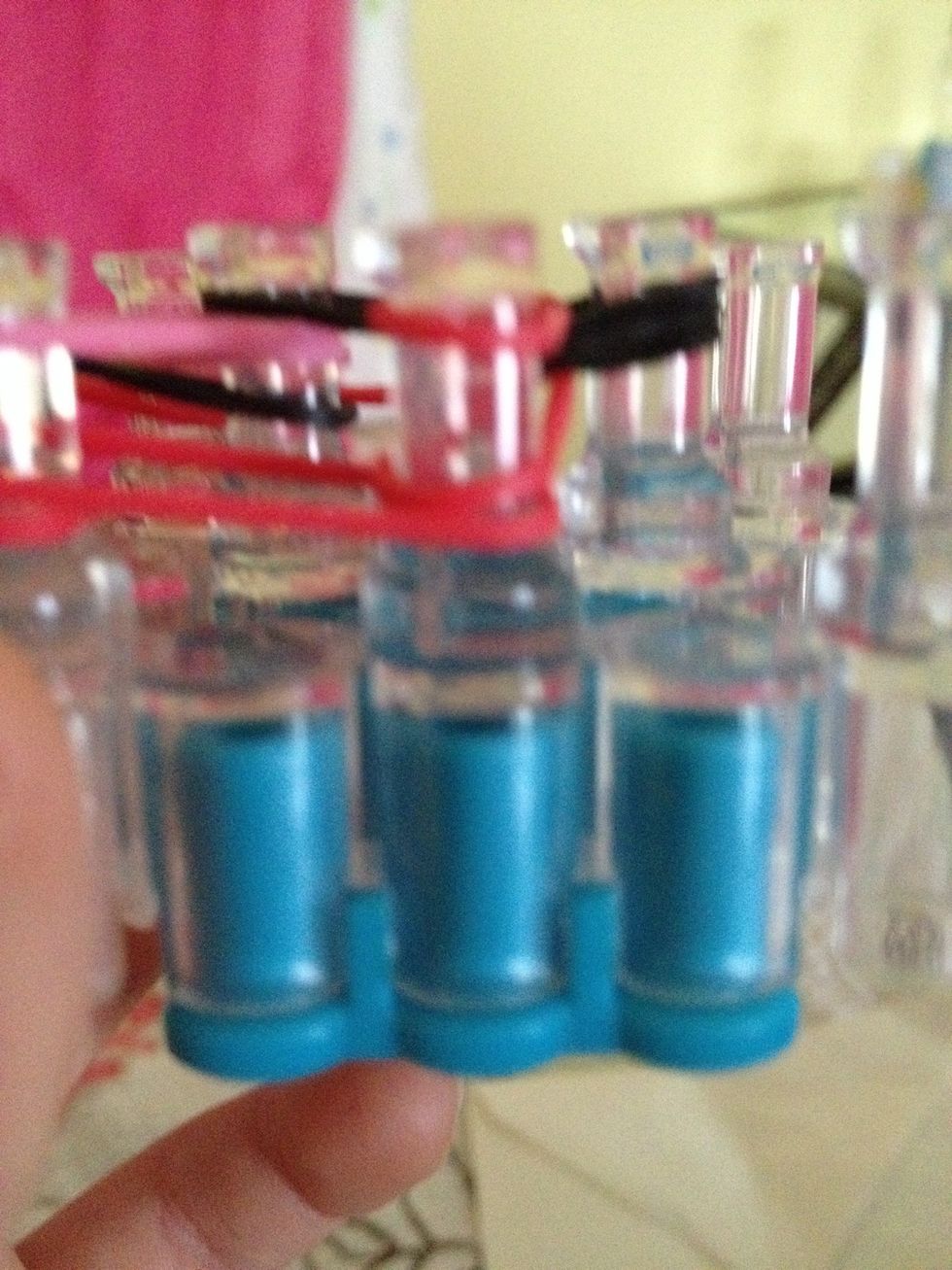 U r going to take the last rubber band on the left and bring it forward to the peg Do the same thing on the right