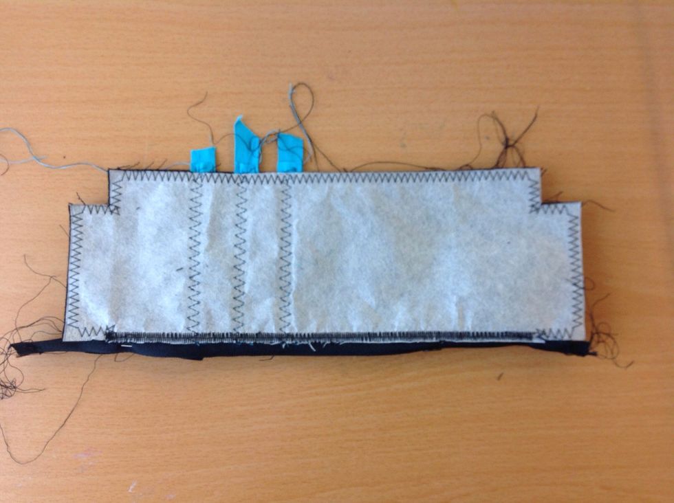 \u00d6ppna dragkedjan en bit. Vik ihop pennskrinet med avigsidan (baksidan) ut. Tv\u00e4rn\u00e5la l\u00e4ngs kanterna.