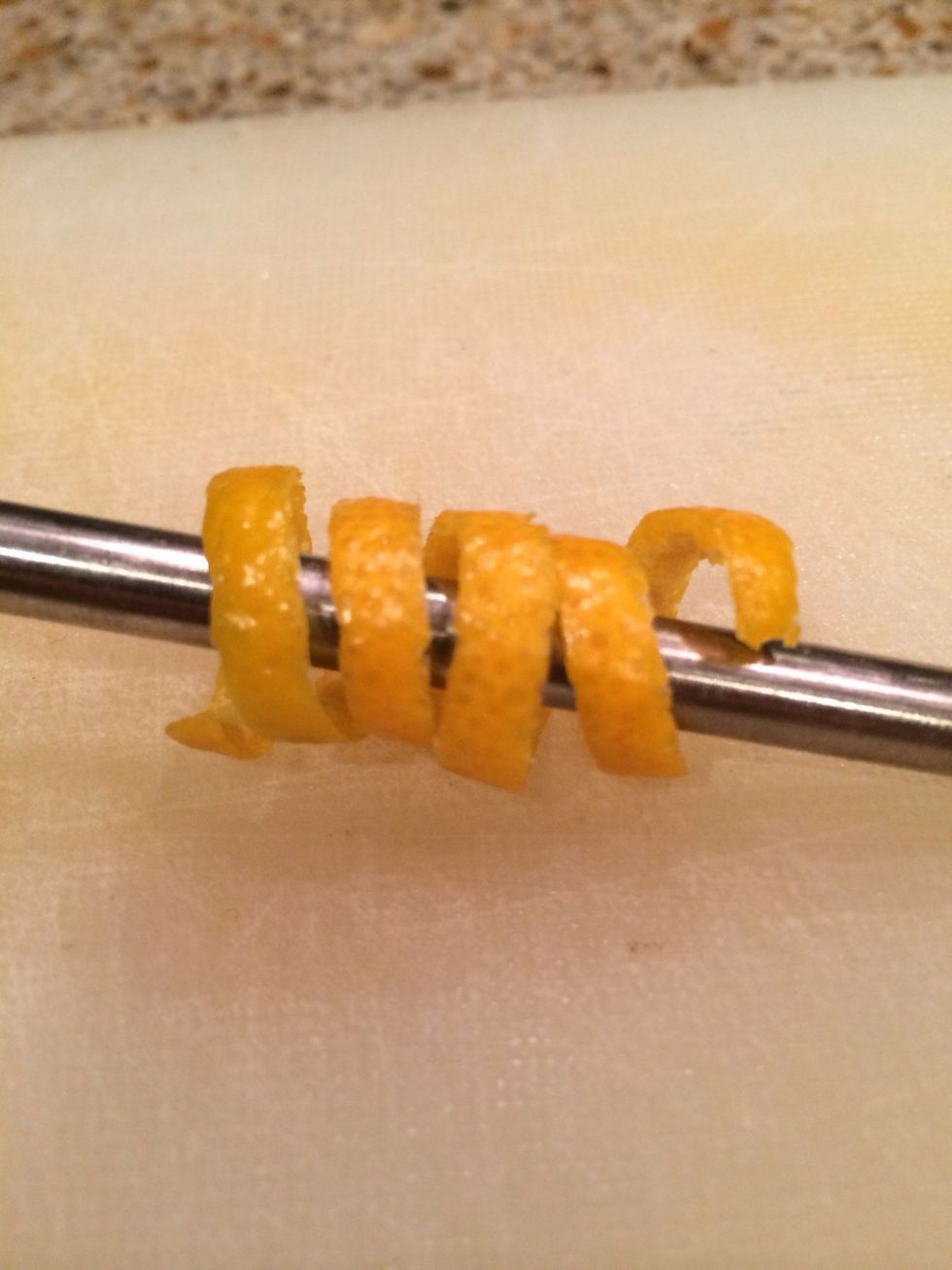 \u2026and twirl it around a thin rod to create an orange twist. Like I said, presentation is important to impress your guests.