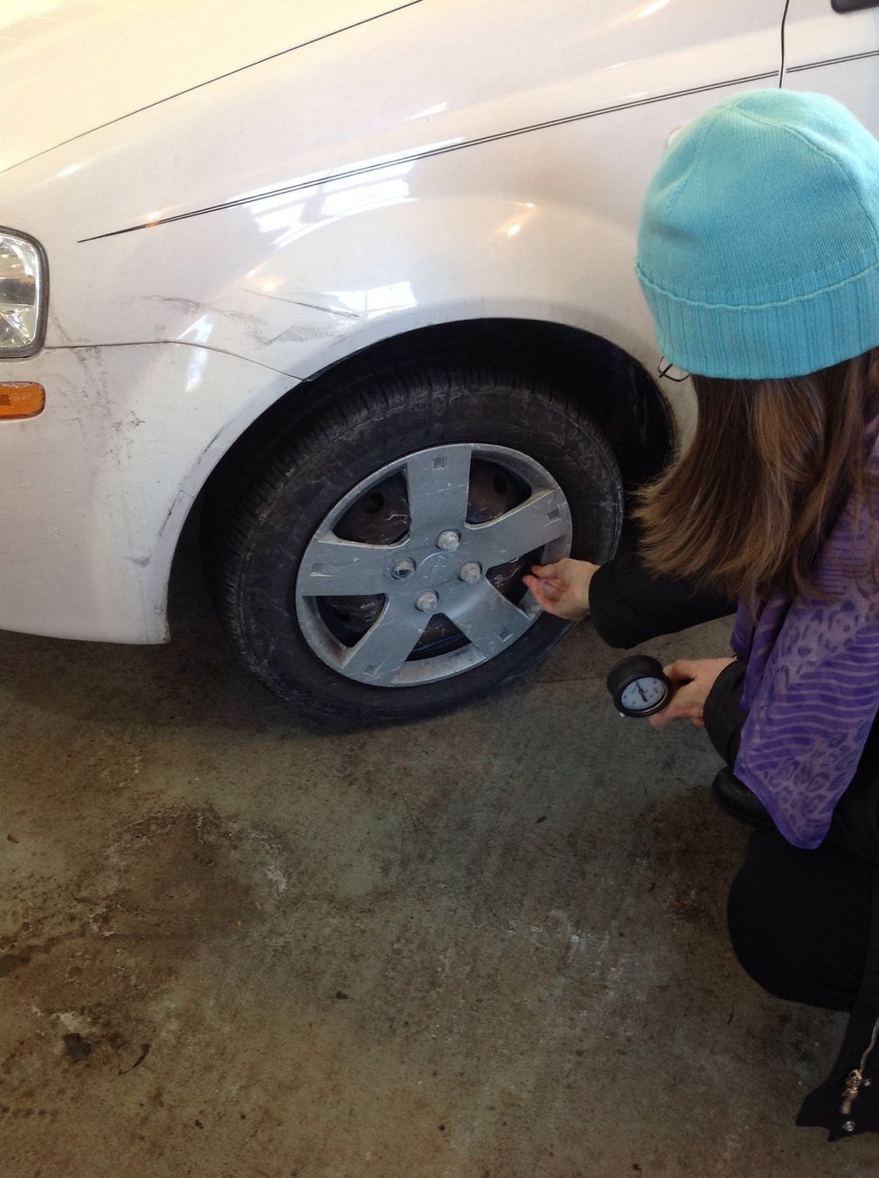 Uncap the tire valve and put the cap in a safe place where it won't roll away.