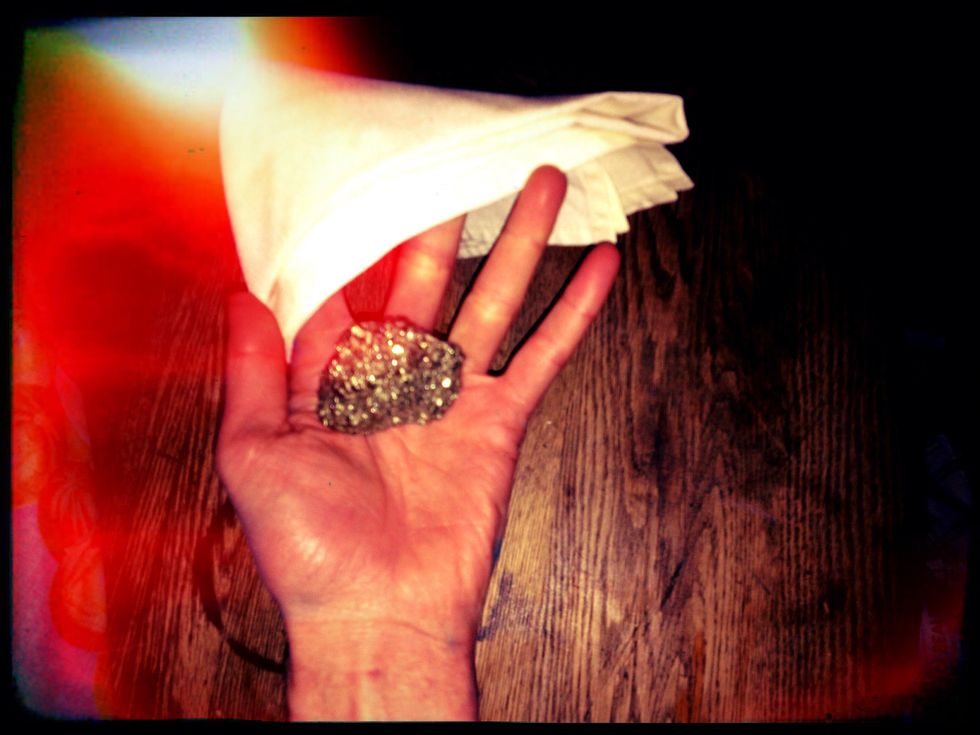 Uncle Fred waited a second or two, and then whipped the handkerchief off his palm. To our sheer amazement, the pebble was gone. In its place sat a gleaming nugget of gold.