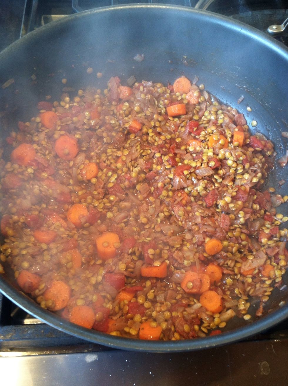 Uncover bring heat up to medium high - add wine and mix uncovered then decrease heat back to simmer.