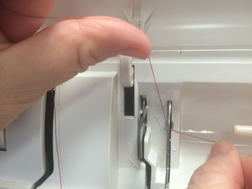 under that first thread guide...and watching the arrow, take the thread over the second thread guide