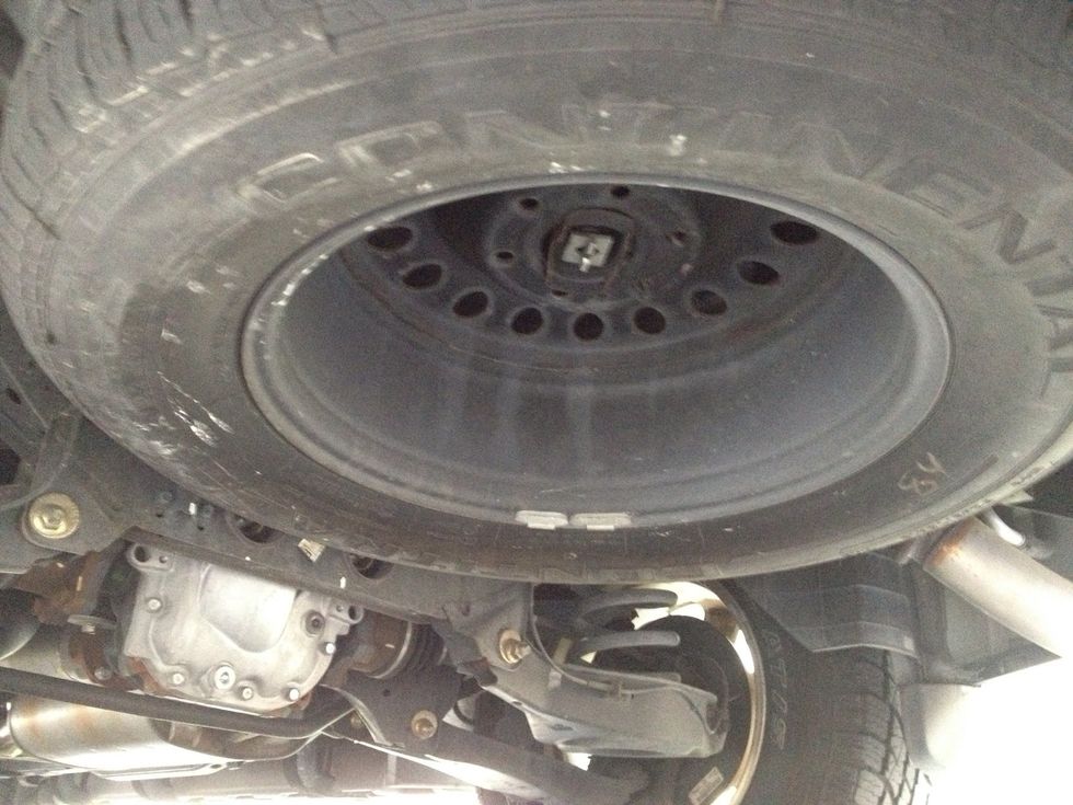 Under the back, this is what it looks like for the spare tire for my SUV