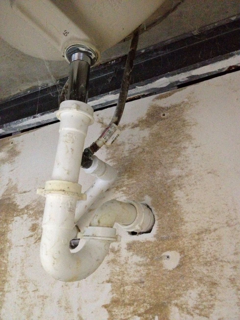 Under the sink you'll see some pipes. The J-shapes pipe is called the "trap". This is because it traps the nasty sewer smell from coming up and traps wedding rings from going down. Lucky you!